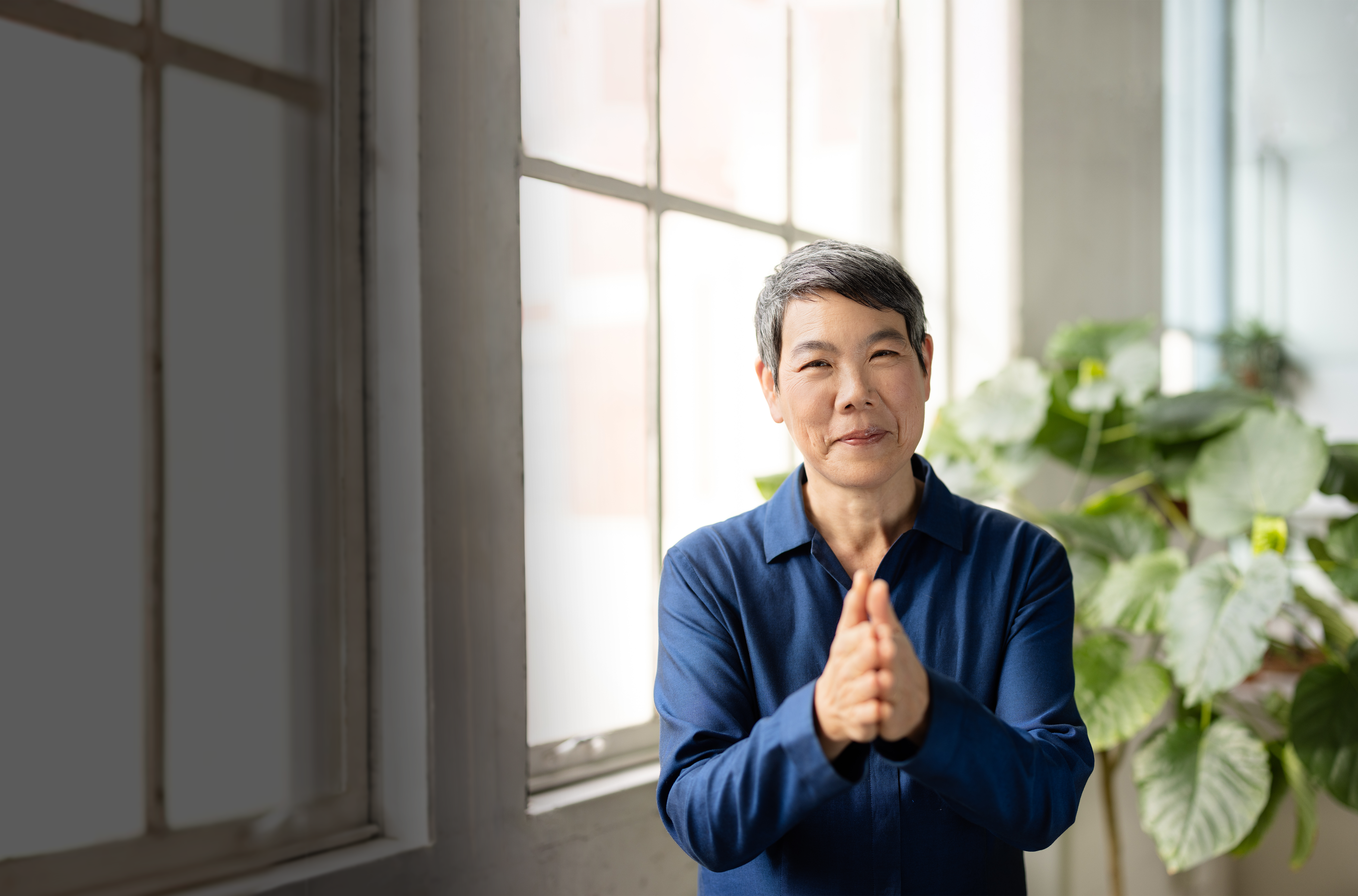 Eveline Shen standing with hands pressed together.